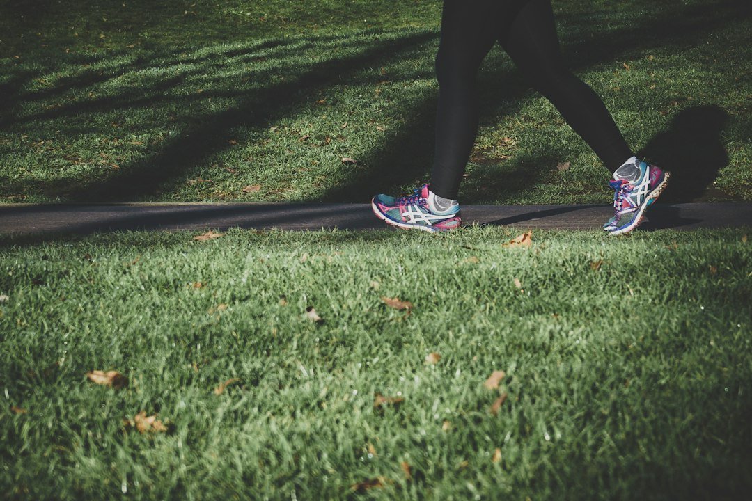Custom Bracing & Orthotics 4 shallow focus photography of person walking on road between grass